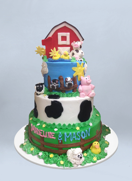 Photo: frosted 4 tier cake with farm animals and barn