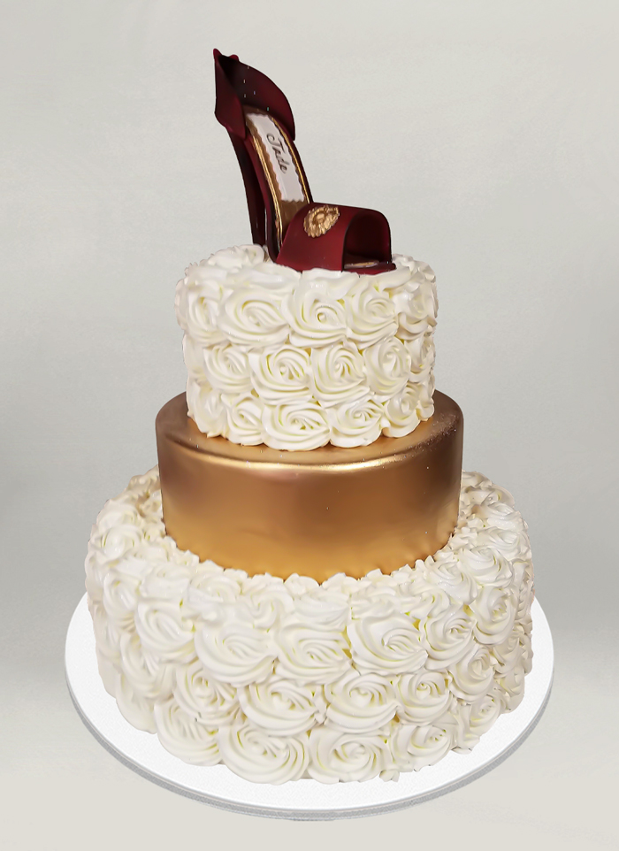 Photo: piped rose tiered cake with a heeled shoe on top