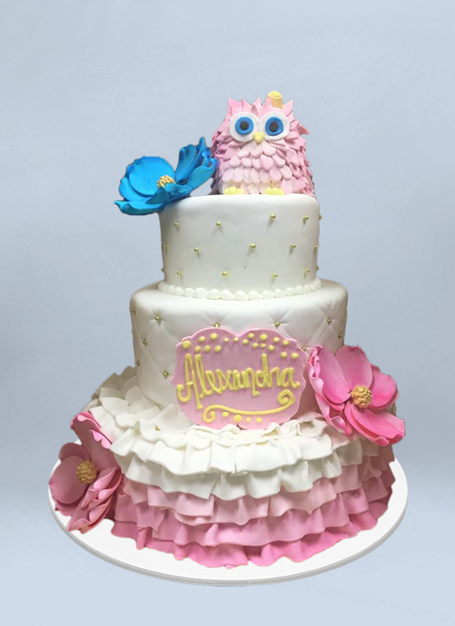 Photo: 3 tier fondant cake with sugar flowers and pink owl on top