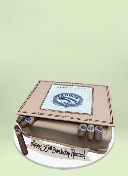 Photo: fondant covered cake shaped like cigar box with cigars sticked out