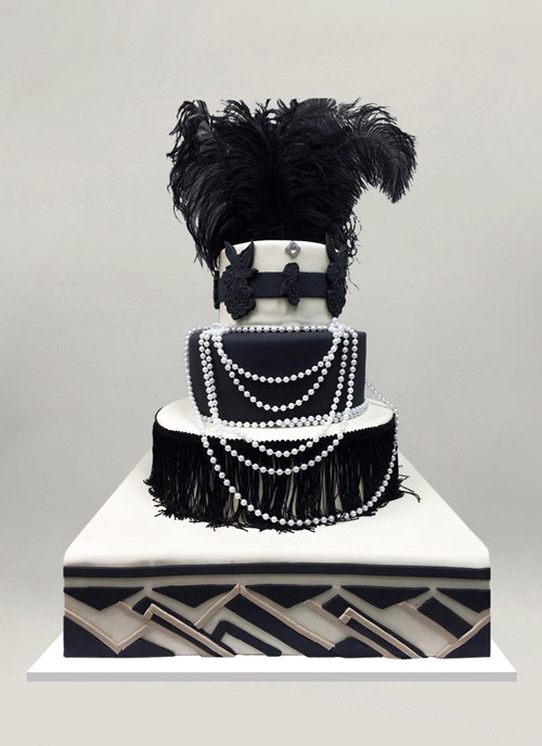 Photo: black and white fondant cake with flapper elements on each tier, fringes, pearls, feathers