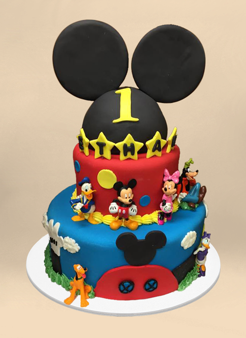 Photo: fondant cake with Mickey Mouse ears and dimensional Mickey characters around the tiers
