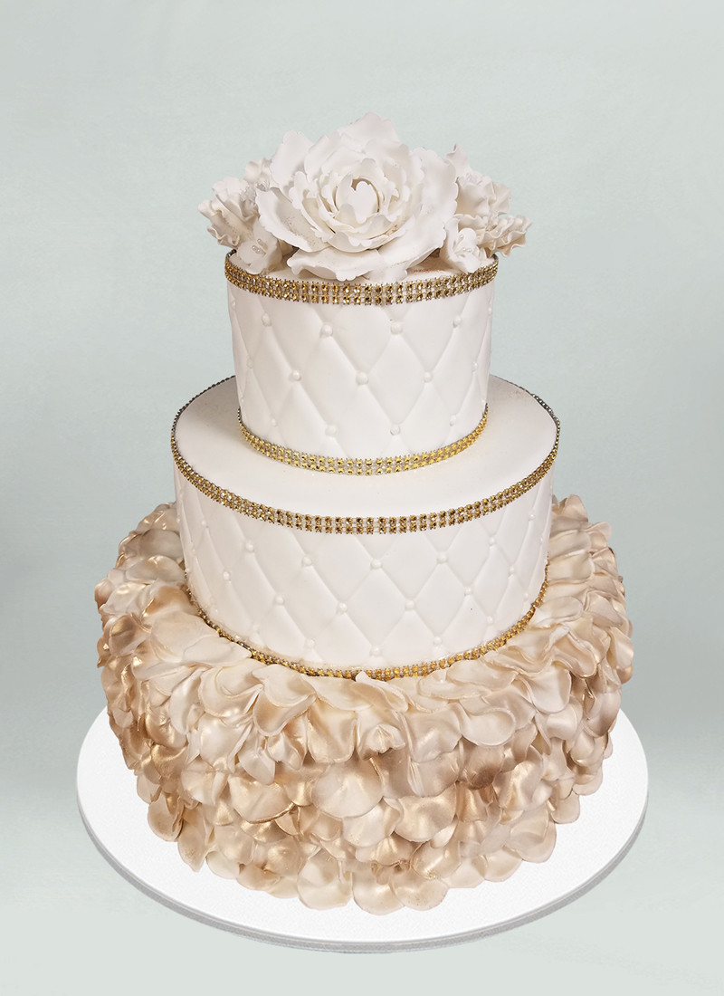 Photo: smooth white cake with gold sugar flowers
