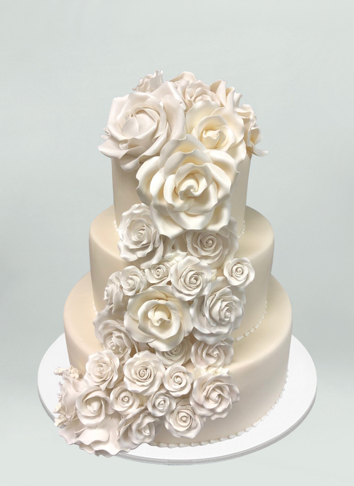 Photo: off white cake with cascading fondant flowers