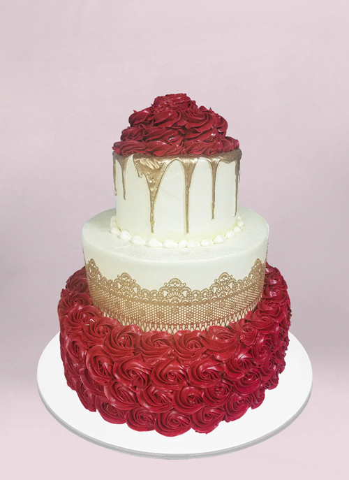 Photo: off white cake with red  piped icing flowers