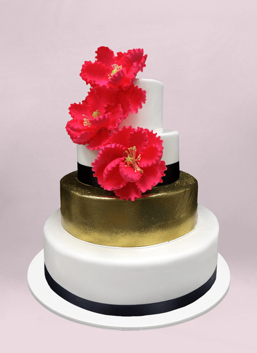Photo: smooth white cake with one solid gold tier and three giant red sugar flowers